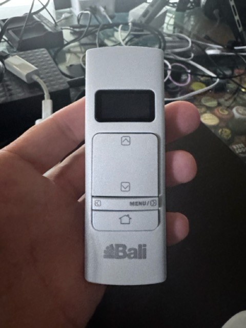 Front of a Bali AutoView Premium Z-Wave remote with screen and menu controls
